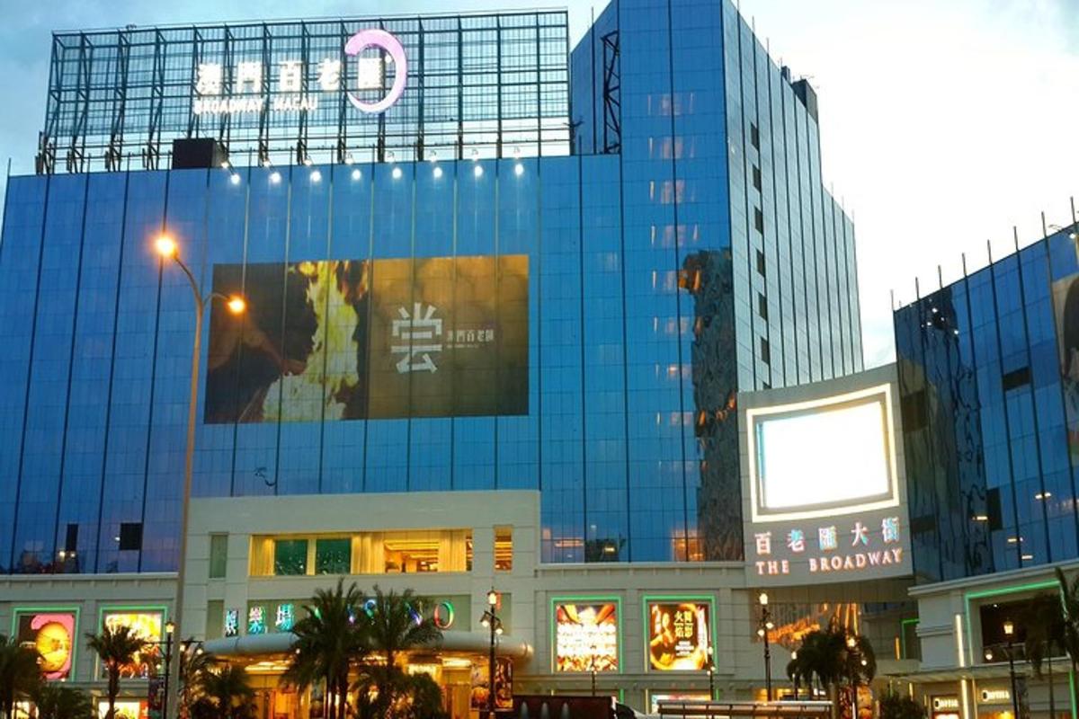 a large glass building with a sign on it