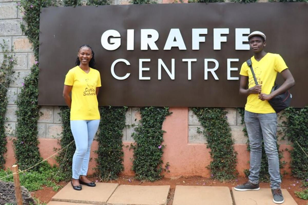 a man and a woman standing in front of a sign