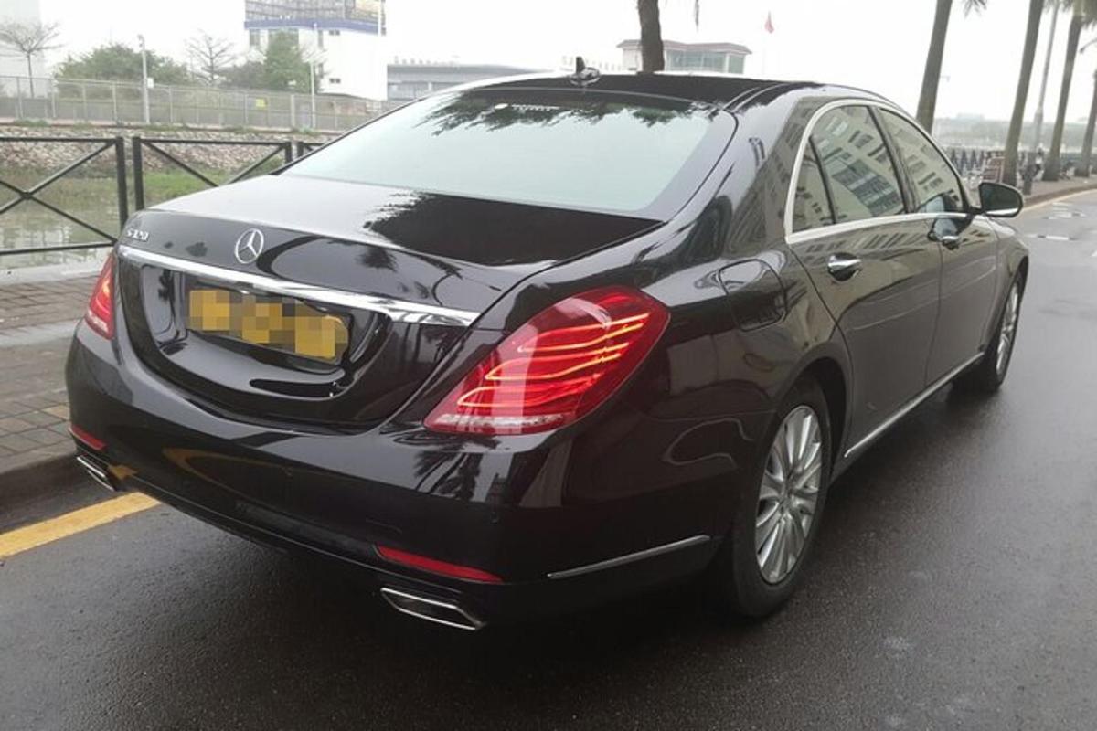 a black car is parked on a road