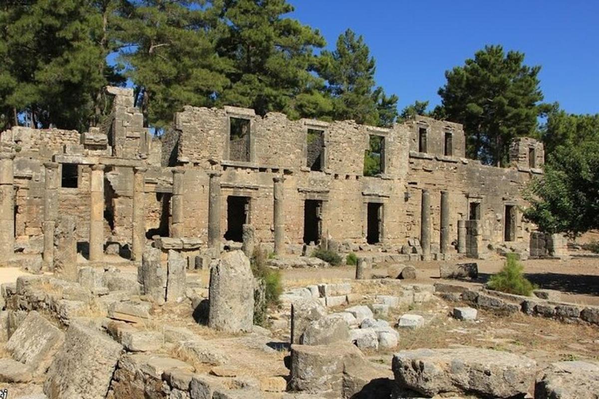 Un antiguo edificio de piedra con árboles al fondo.