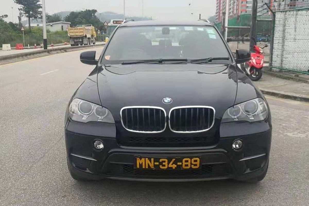 a black car parked on the side of a road