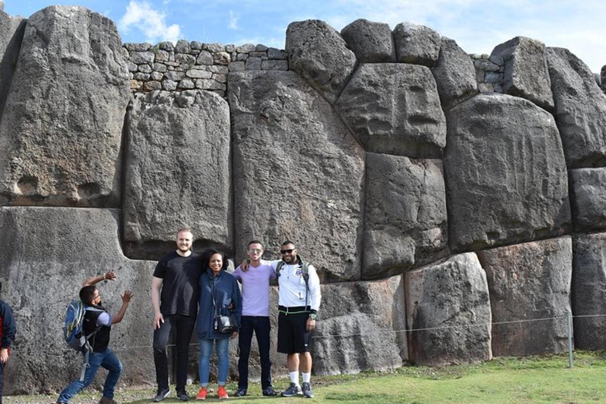 isang grupo ng mga tao na nakatayo sa harap ng isang rock formation
