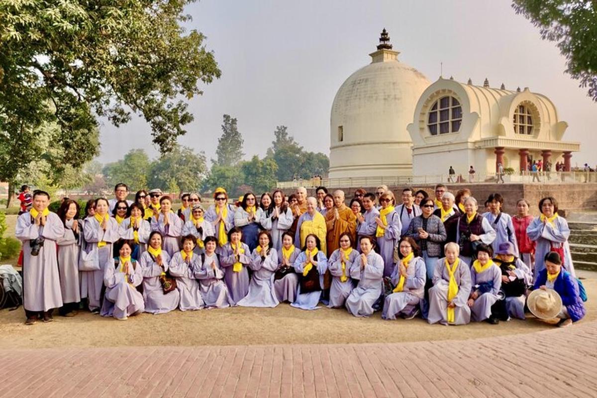 a group of people posing for a picture in front of a building