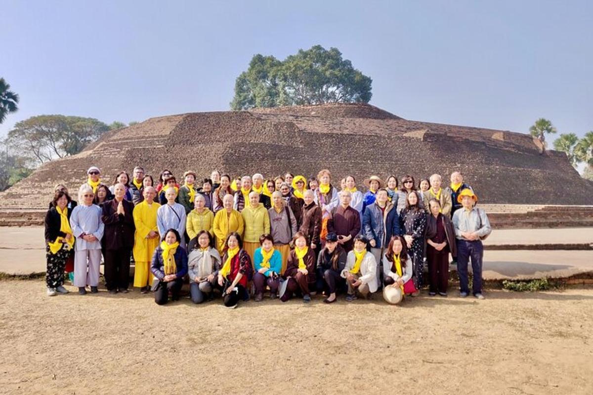 a group of people posing for a picture in front of a pyramid