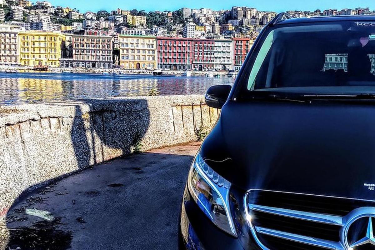 a black car parked next to a body of water