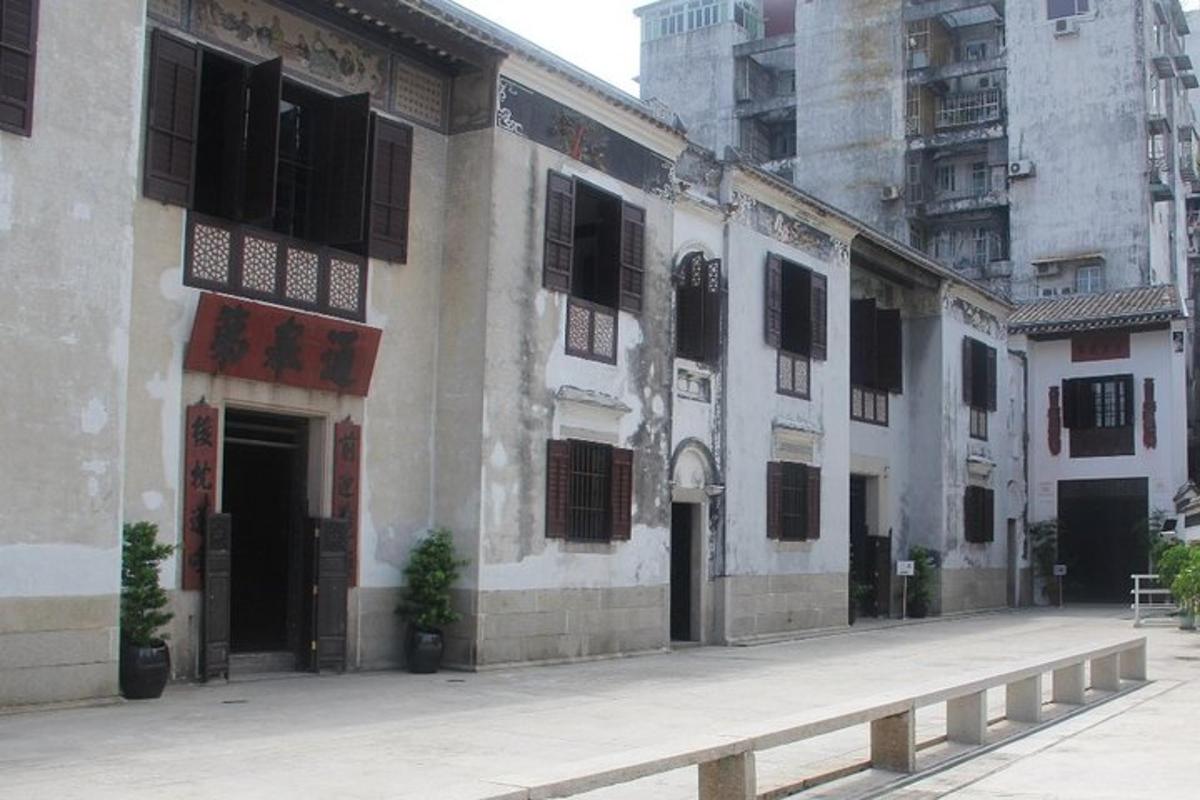 a building with black shutters on the side of it