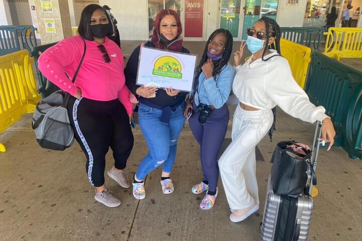 eine Gruppe von Frauen, die auf einem Flughafen für ein Foto posieren
