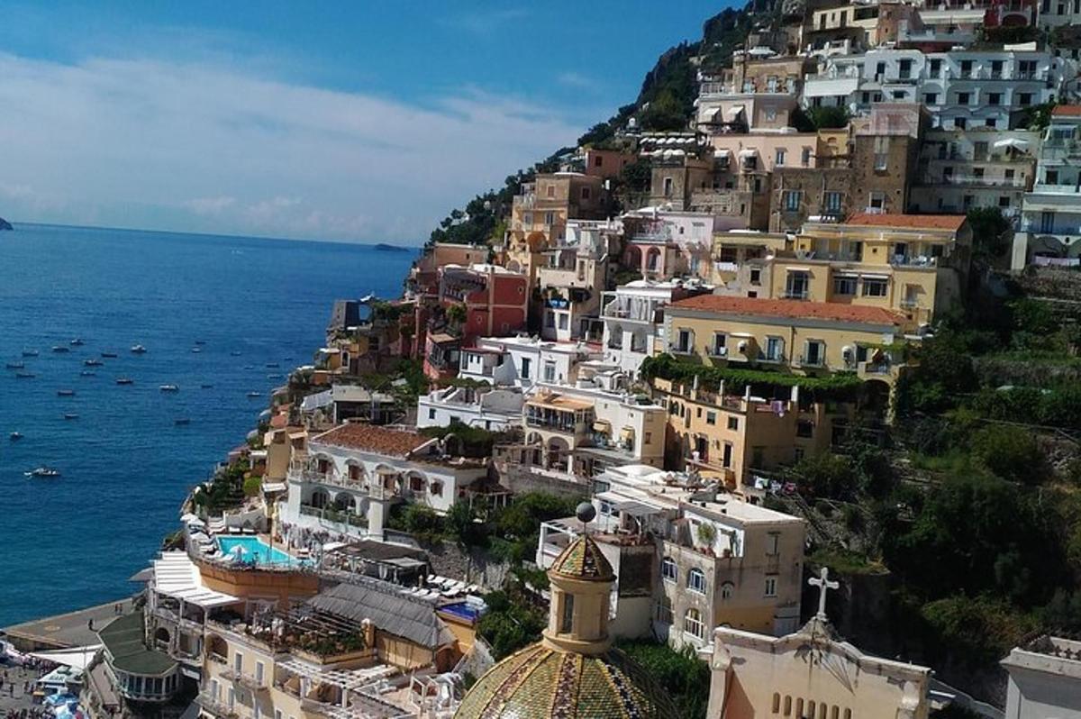 a group of buildings on a hill next to the ocean