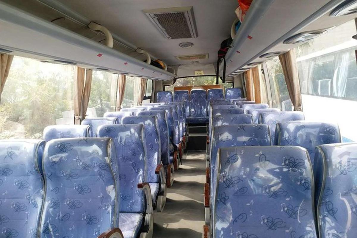 an empty train car with blue seats on