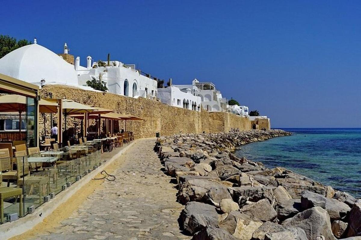 a beach with a group of buildings and the ocean