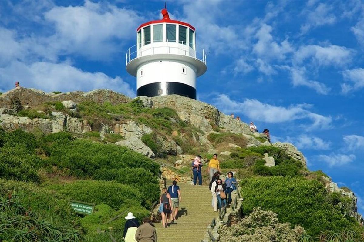 people walking up the stairs to a lighthouse