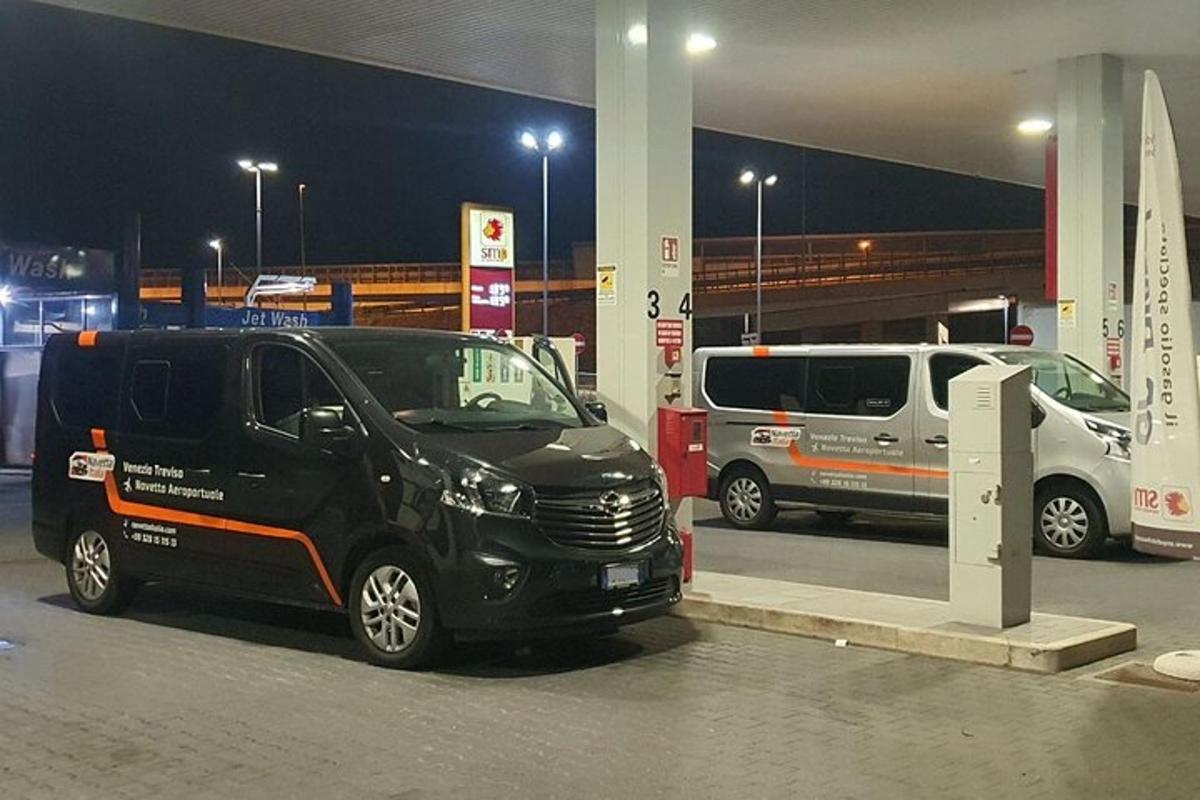 un furgone nero parcheggiato in una stazione di servizio di notte