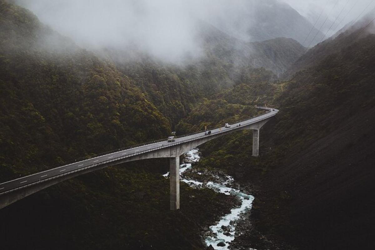 a group of people on a bridge in the mountains