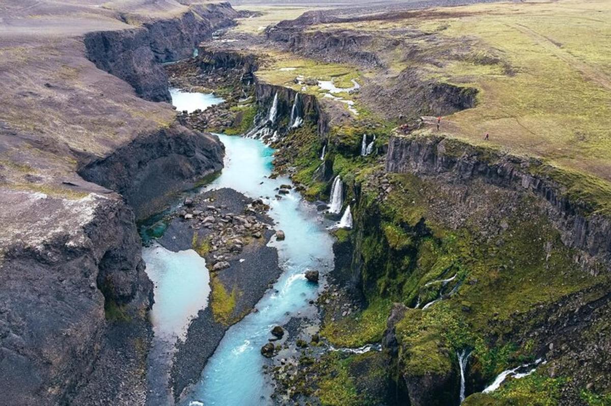 an aerial view of a river flowing through a canyon
