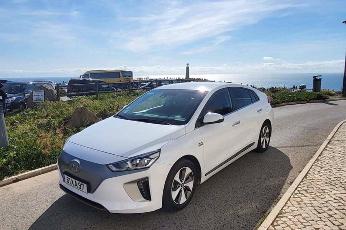 biele auto zaparkované na kraji cesty