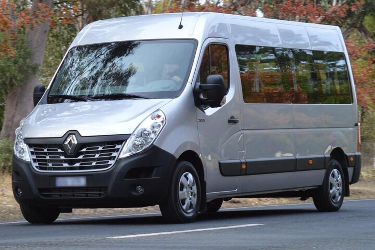 a silver van driving down a road