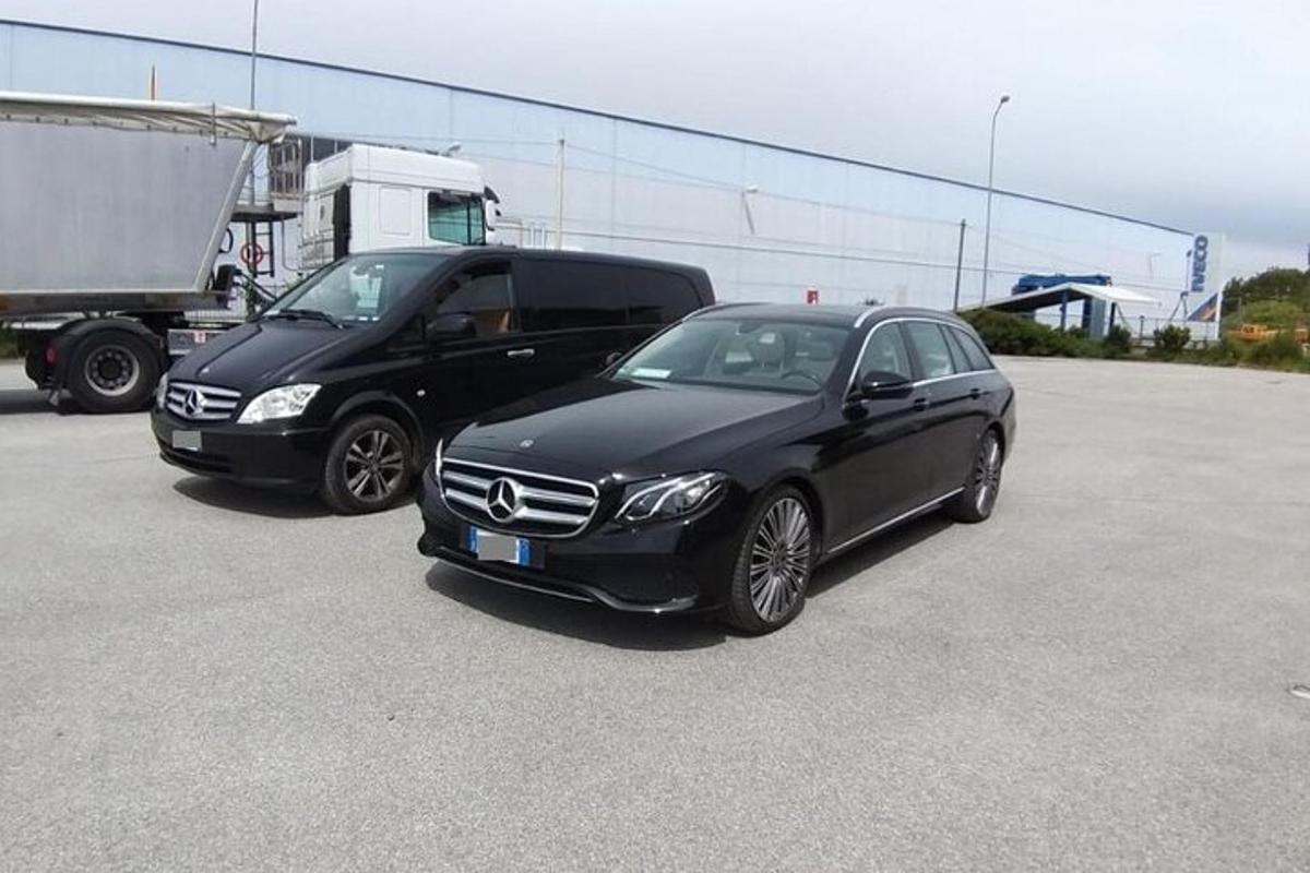 a black car and a black truck in a parking lot