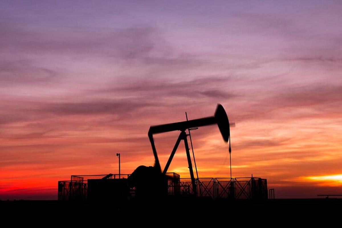 a silhouette of a telescope in front of a sunset