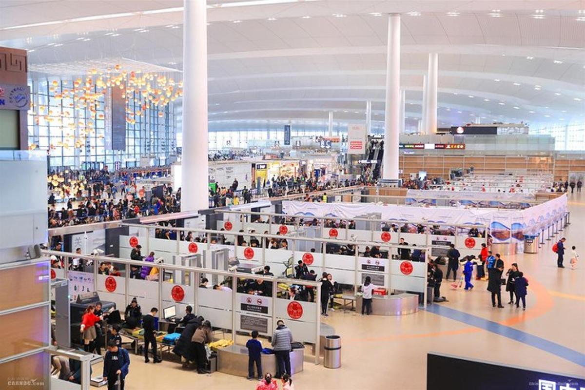 a crowd of people standing around in an airport