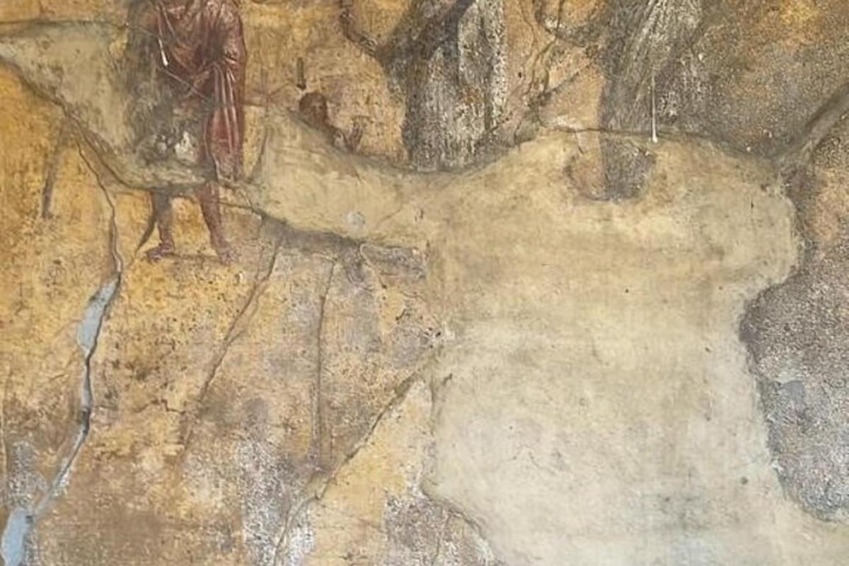 a painting of a man standing on a rock wall