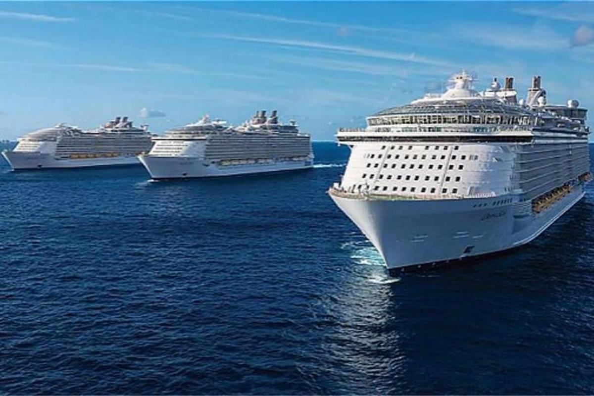 three cruise ships sitting in the ocean