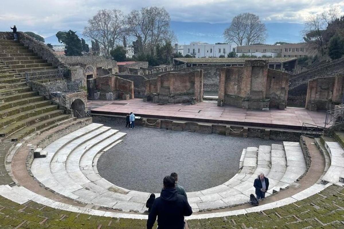 a group of people walking around an amphitheater