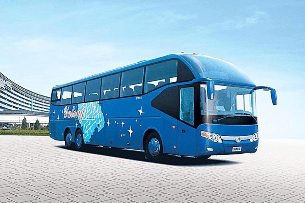 a blue bus parked in a parking lot