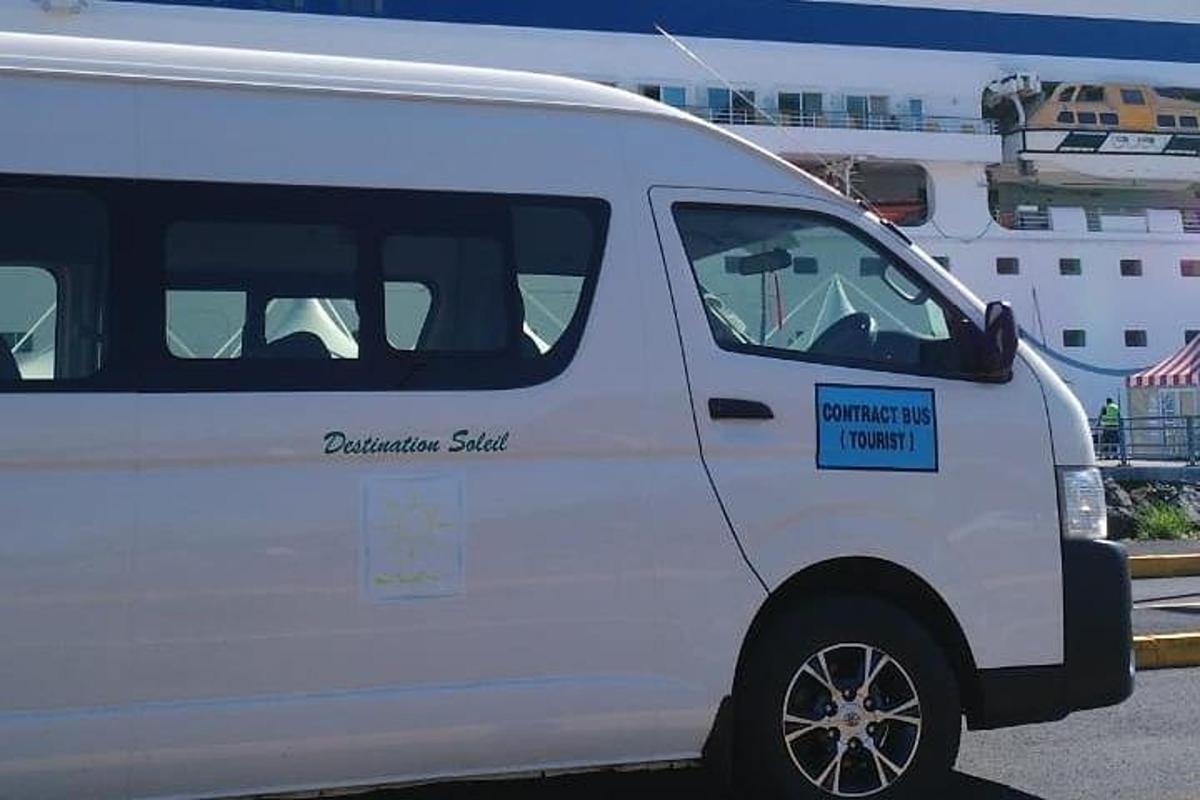 a white van parked next to a cruise ship