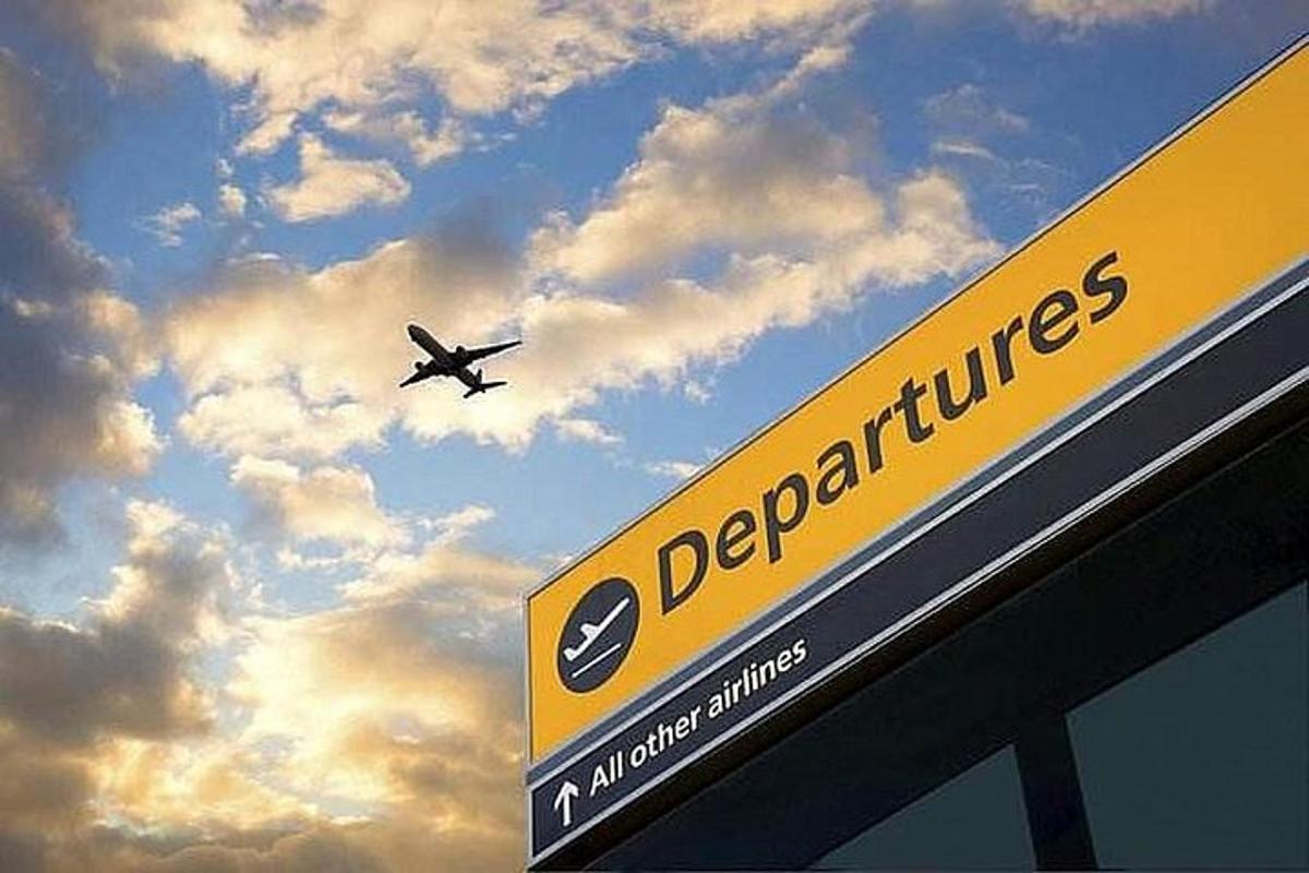 an airplane is flying over a sign with the sky