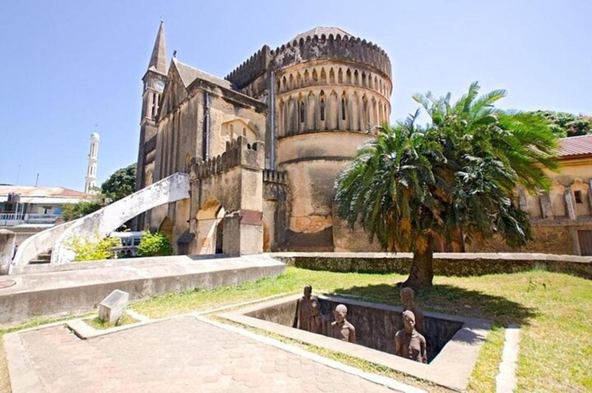 an old building with a palm tree in front of it