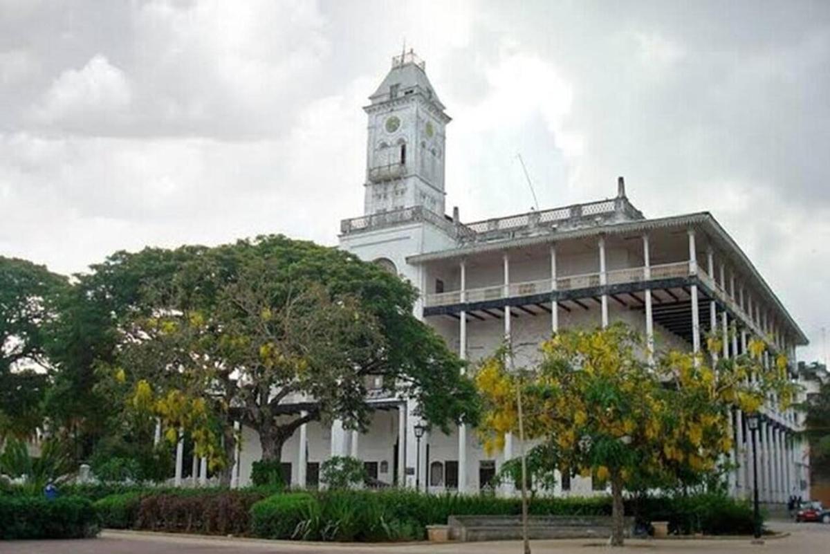 a white building with a clock tower on top of it