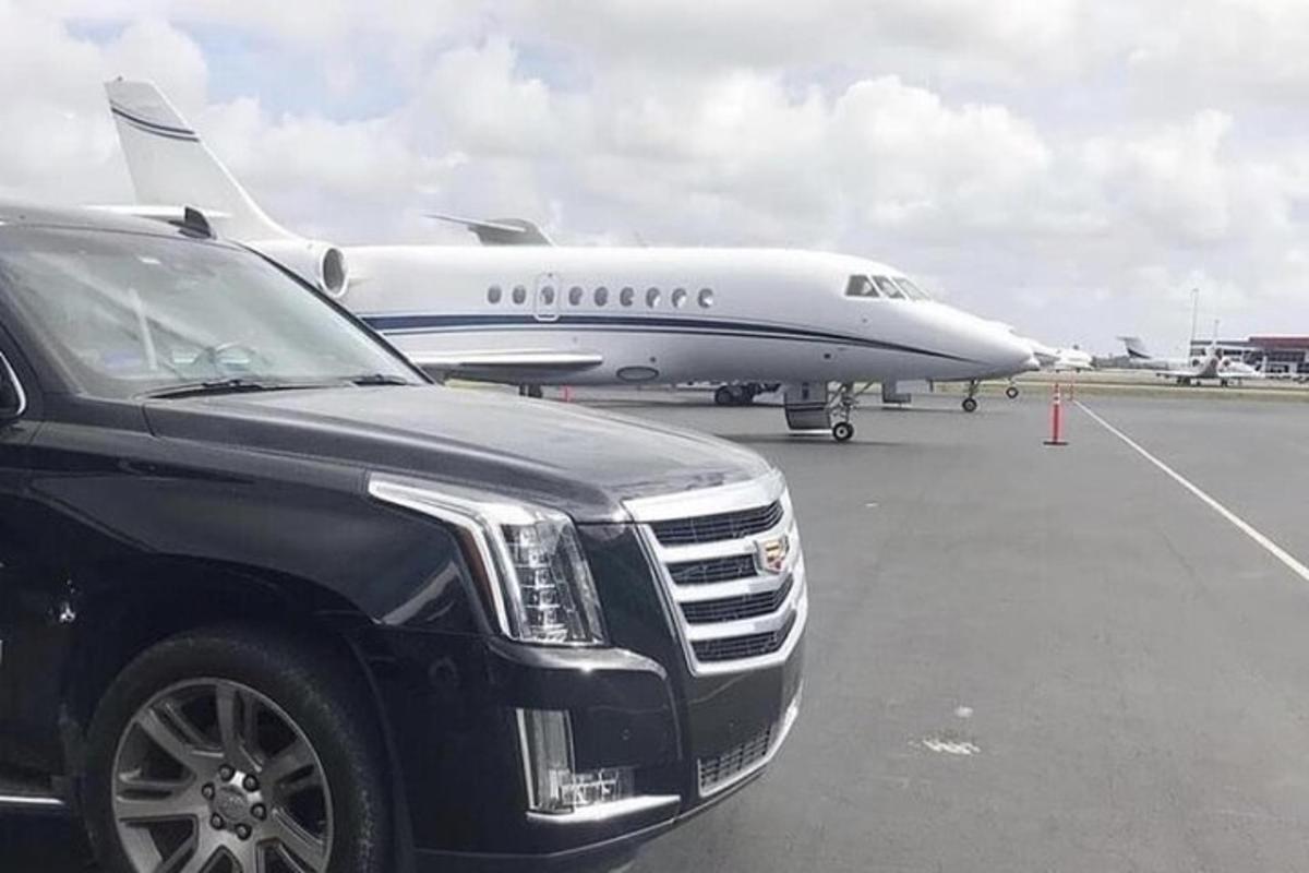 a truck parked in front of an airplane on the runway