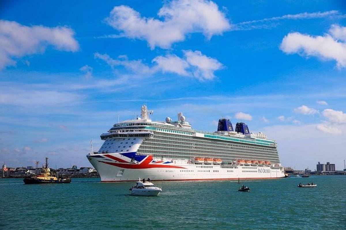 a cruise ship in the ocean with boats in the water