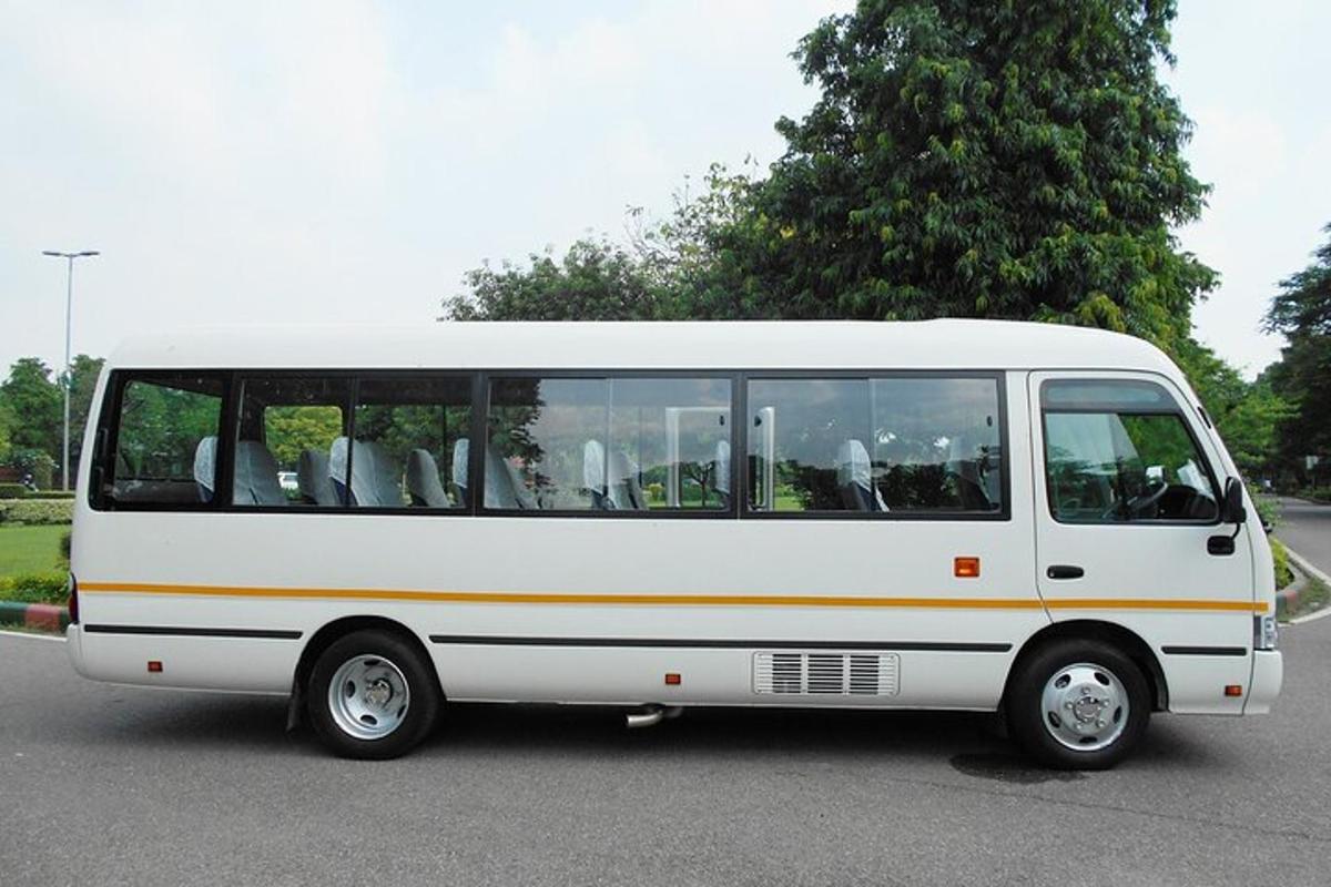 a white bus is parked in a parking lot