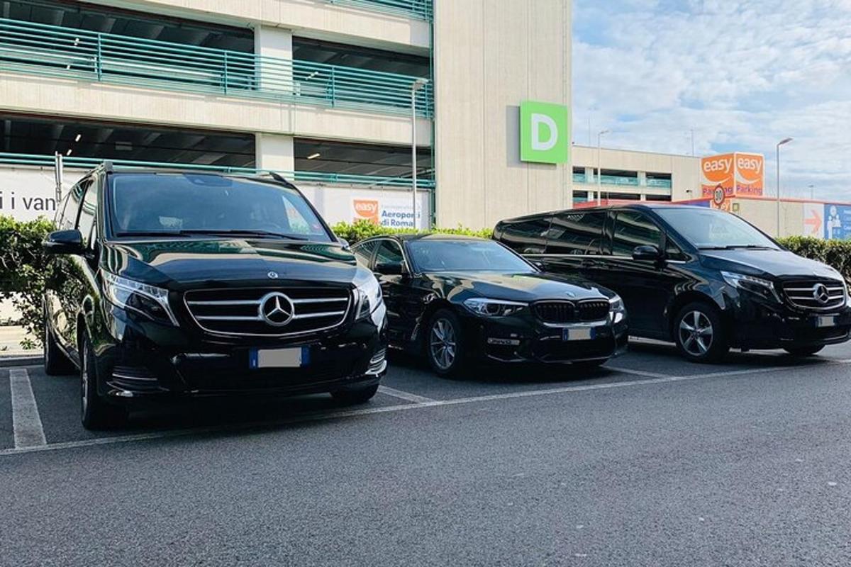 três carros estacionados em um estacionamento em frente a um prédio