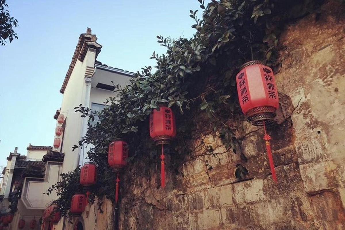 a group of red lanterns on the side of a wall