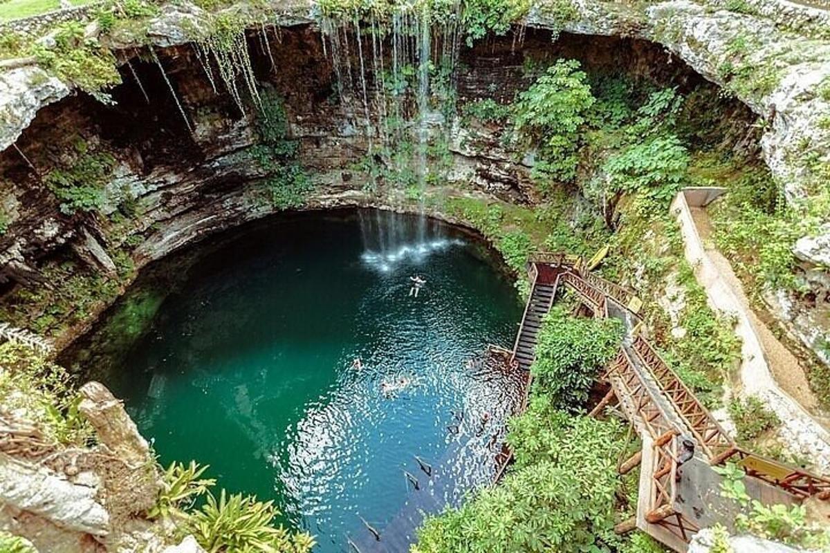 a pool of emerald green water in a cave