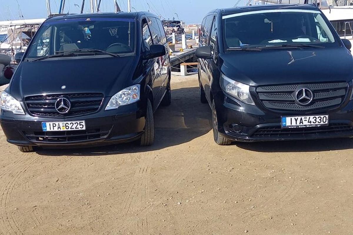 two vehicles parked next to each other on a dirt field