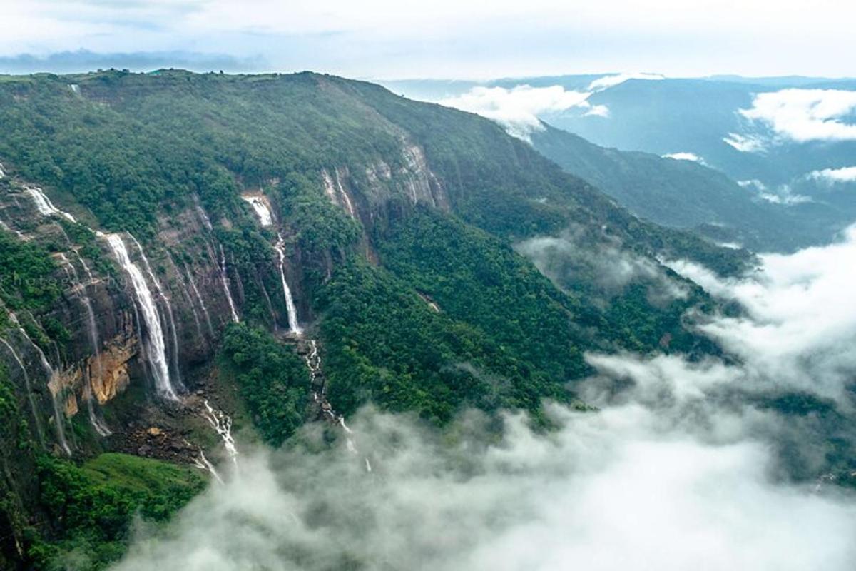 an aerial view of a mountain with two waterfalls