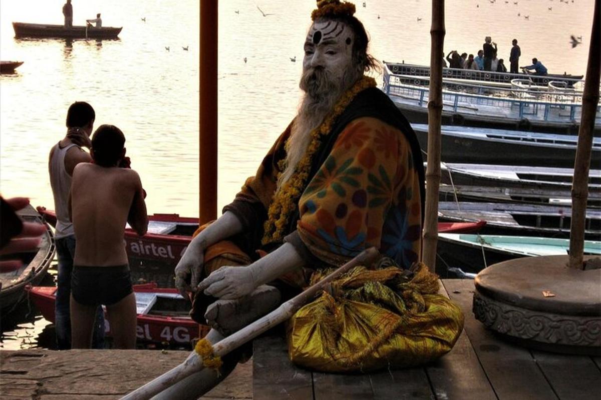 a statue of a man sitting on a dock