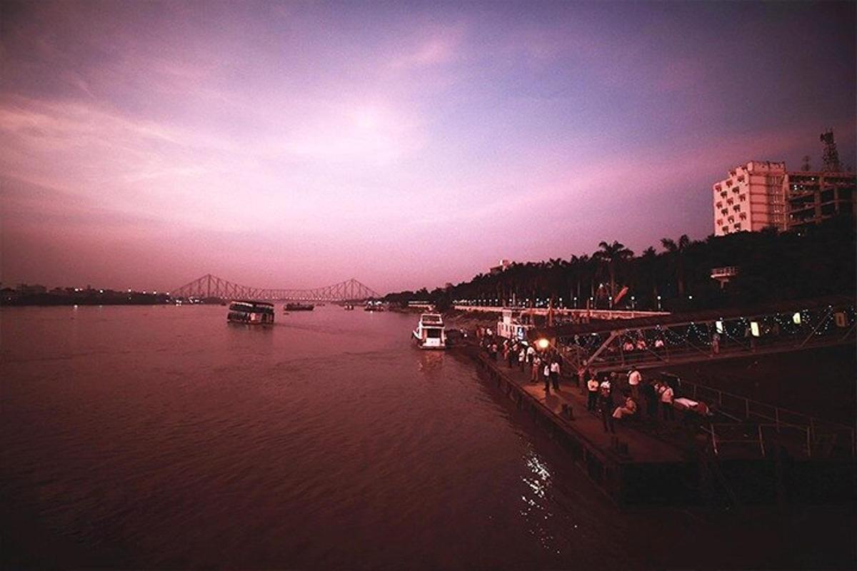 a view of a river with a bridge in the background
