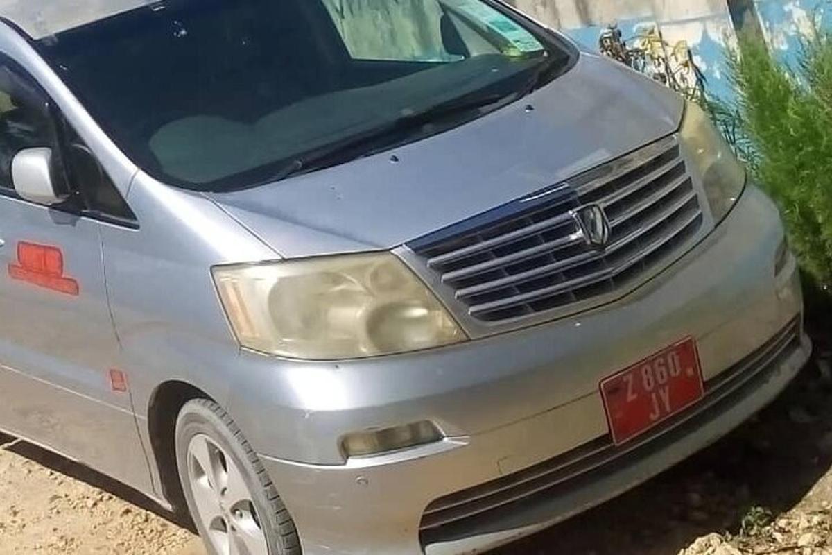 a silver car parked on the side of a road