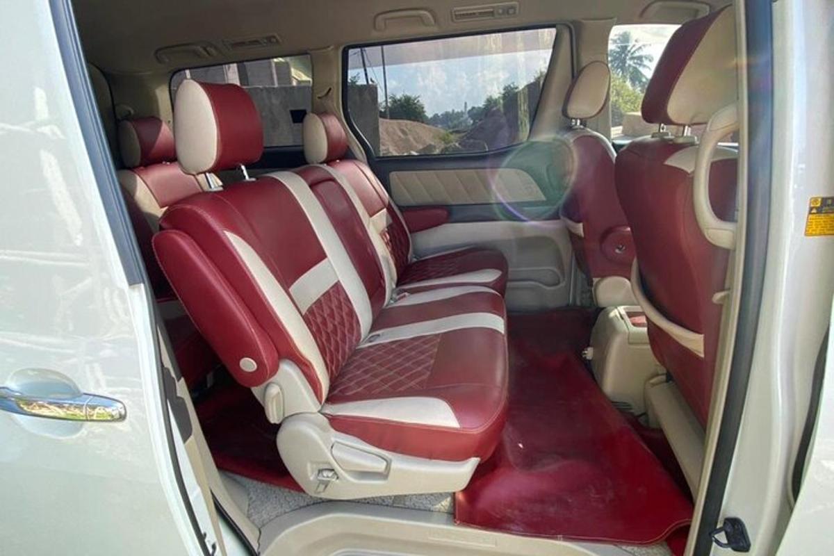 a back seat of a car with red and white seats