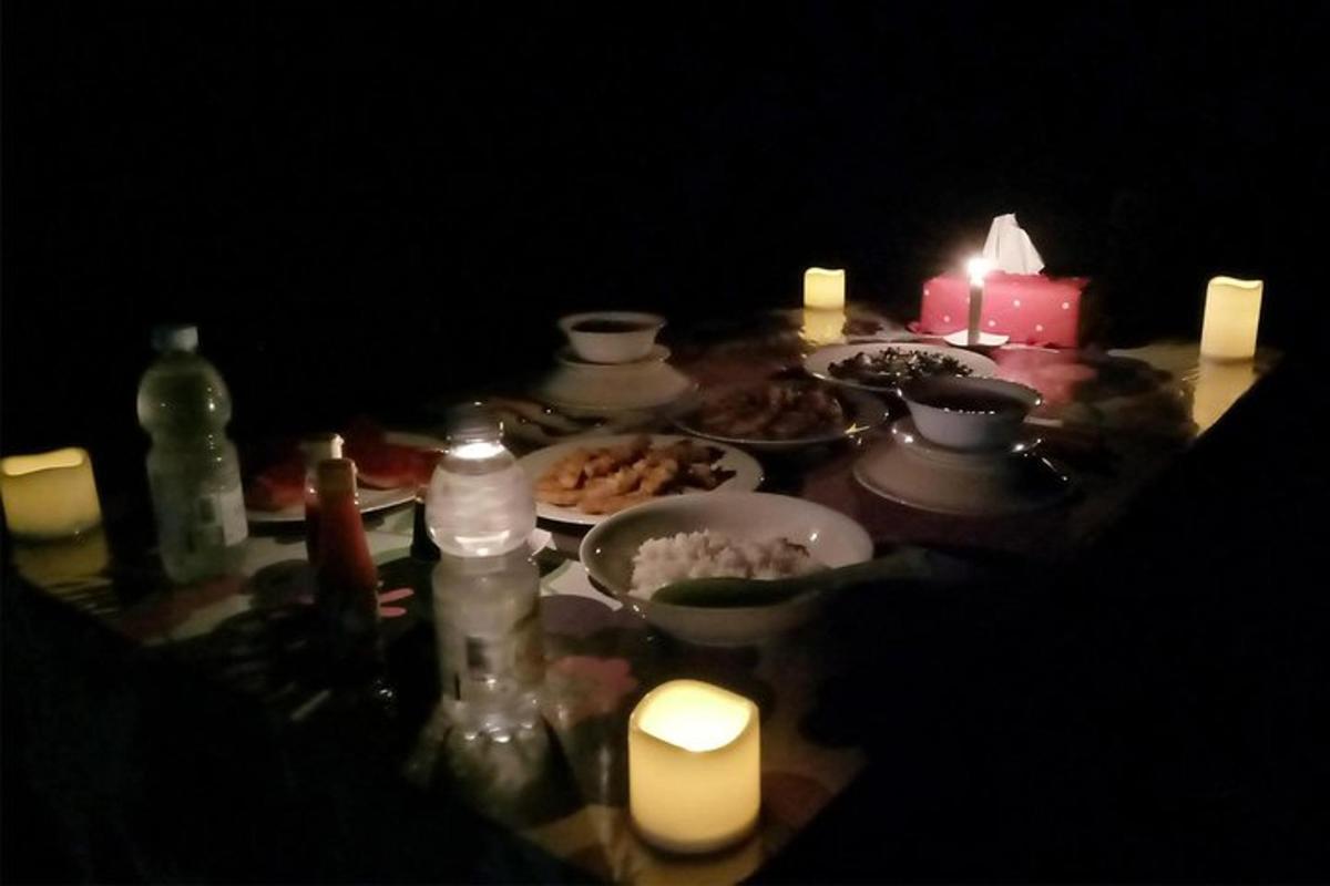 a table with plates of food and candles on it