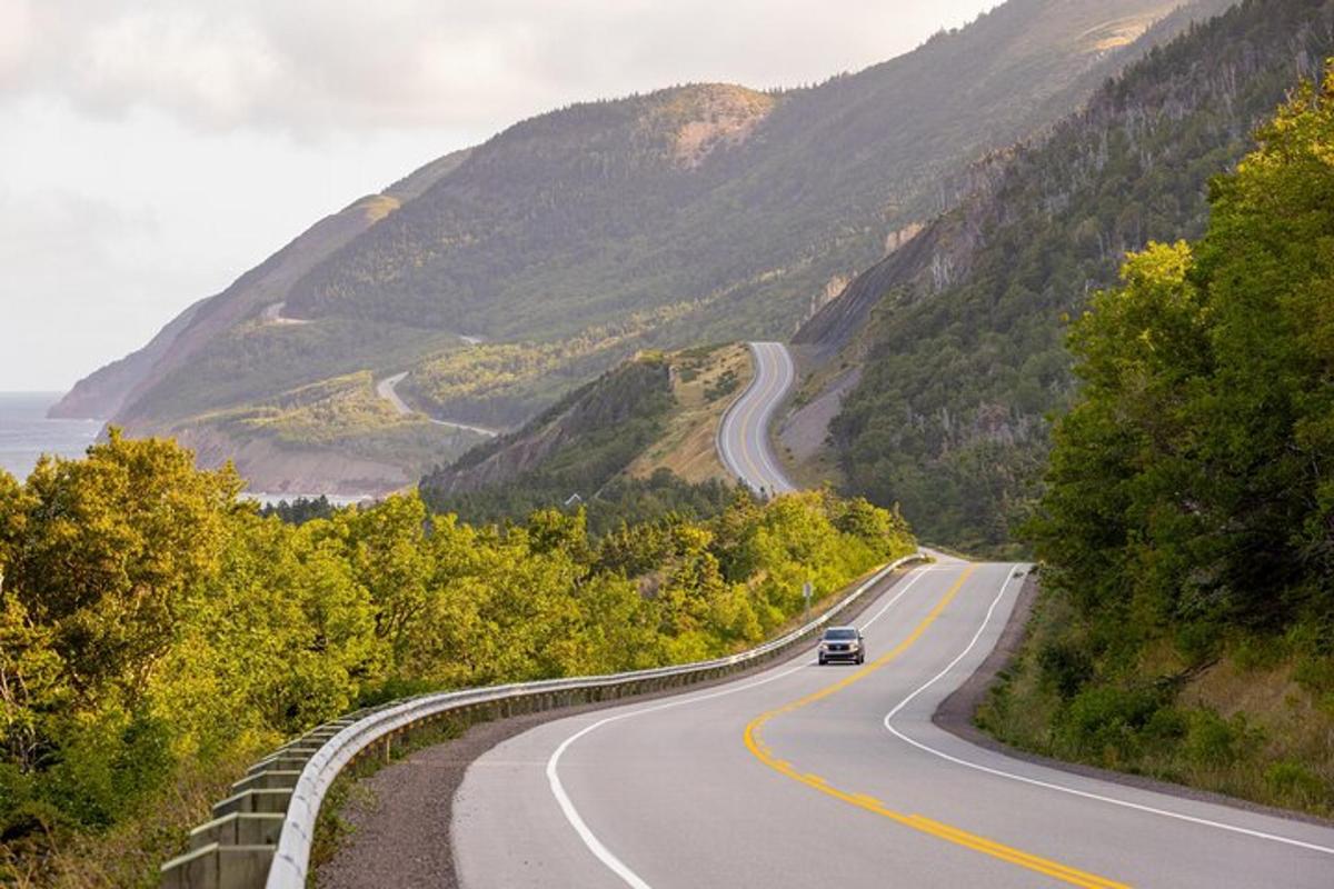 a car driving down a winding road in the mountains