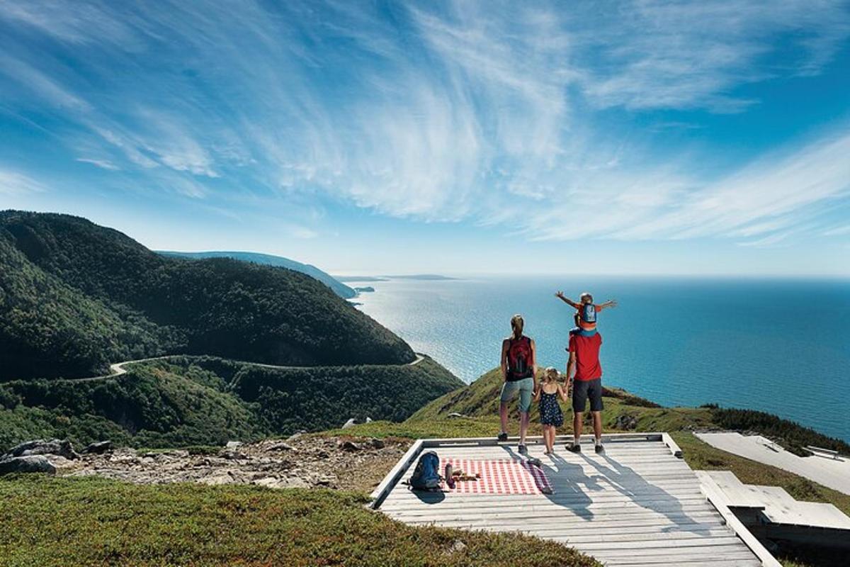 a group of three people standing on top of a mountain