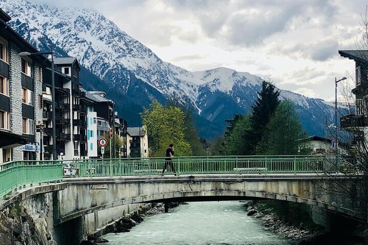 a person walking across a bridge over a river