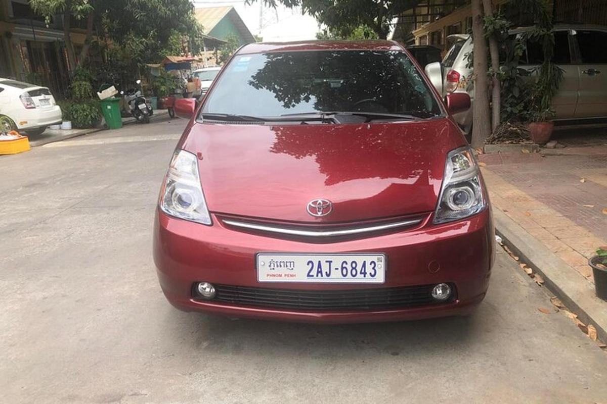 a red car parked on the side of a street