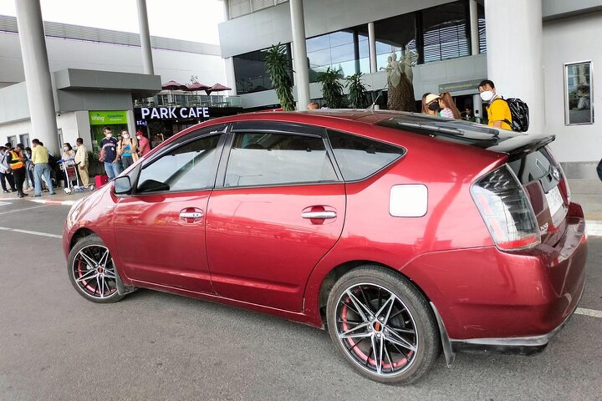 a red car parked in front of a building