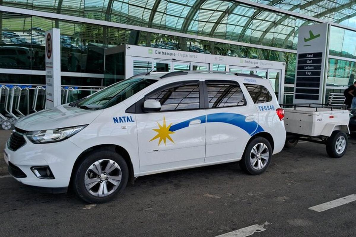 a small white car parked in front of a building